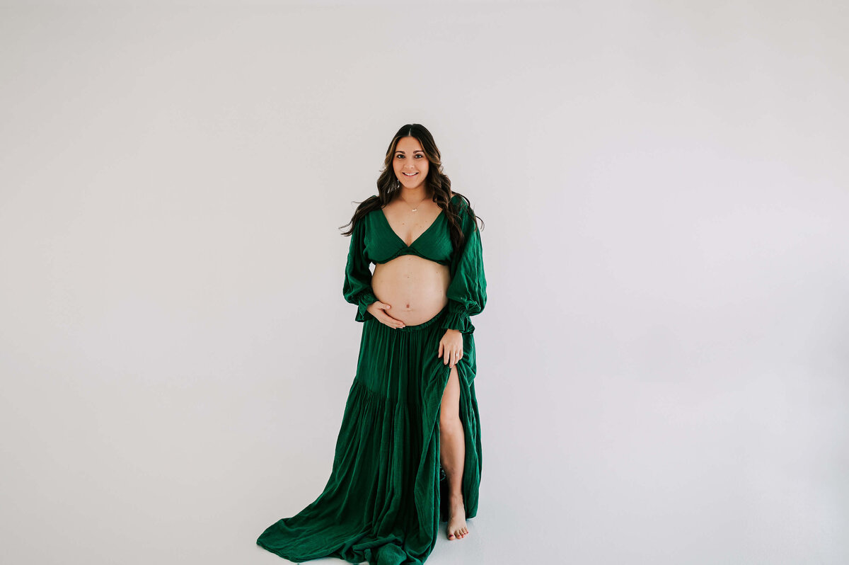 maternity photo in Joplin MO of pregnant mom smiling in studio