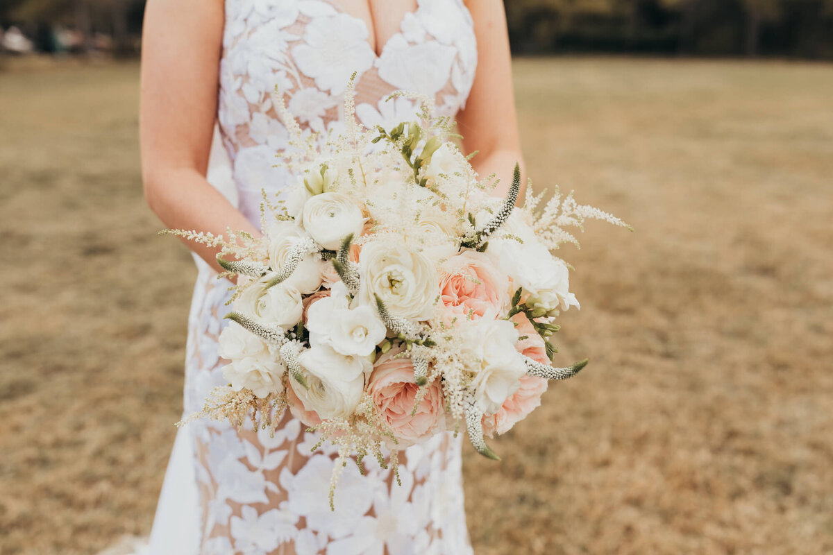 close up of bridal bouquet with white and pink florals.
