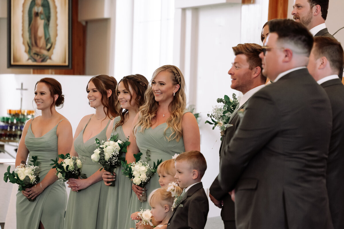 wedding party reactions to bride and groom during ceremony