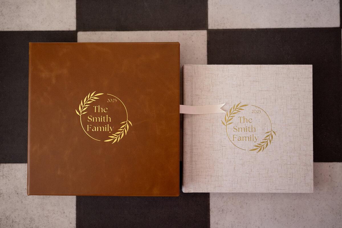 A leather album case and linen album sits on the floor