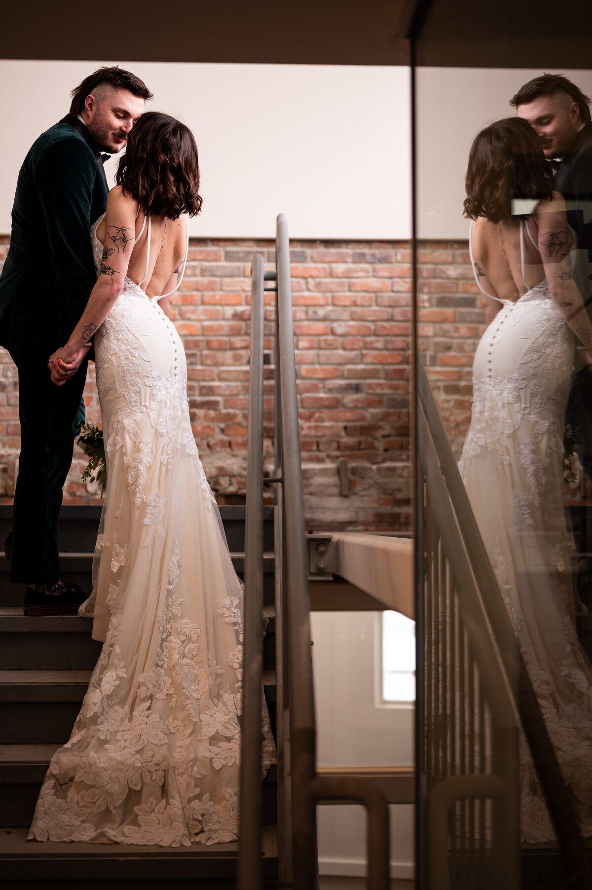 bride and groom kissing in the stairwell at the Pendennis Building, in Edmonton, Alberta