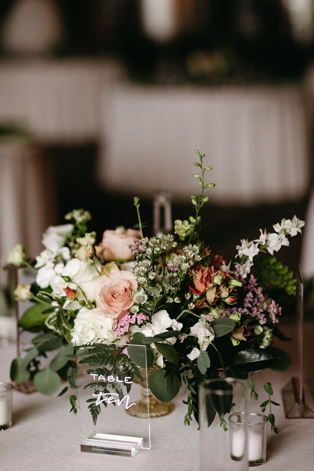 Large floral arrangement by Flowers and Thyme is a lush centerpiece for a wedding reception table at Maysara Winery.