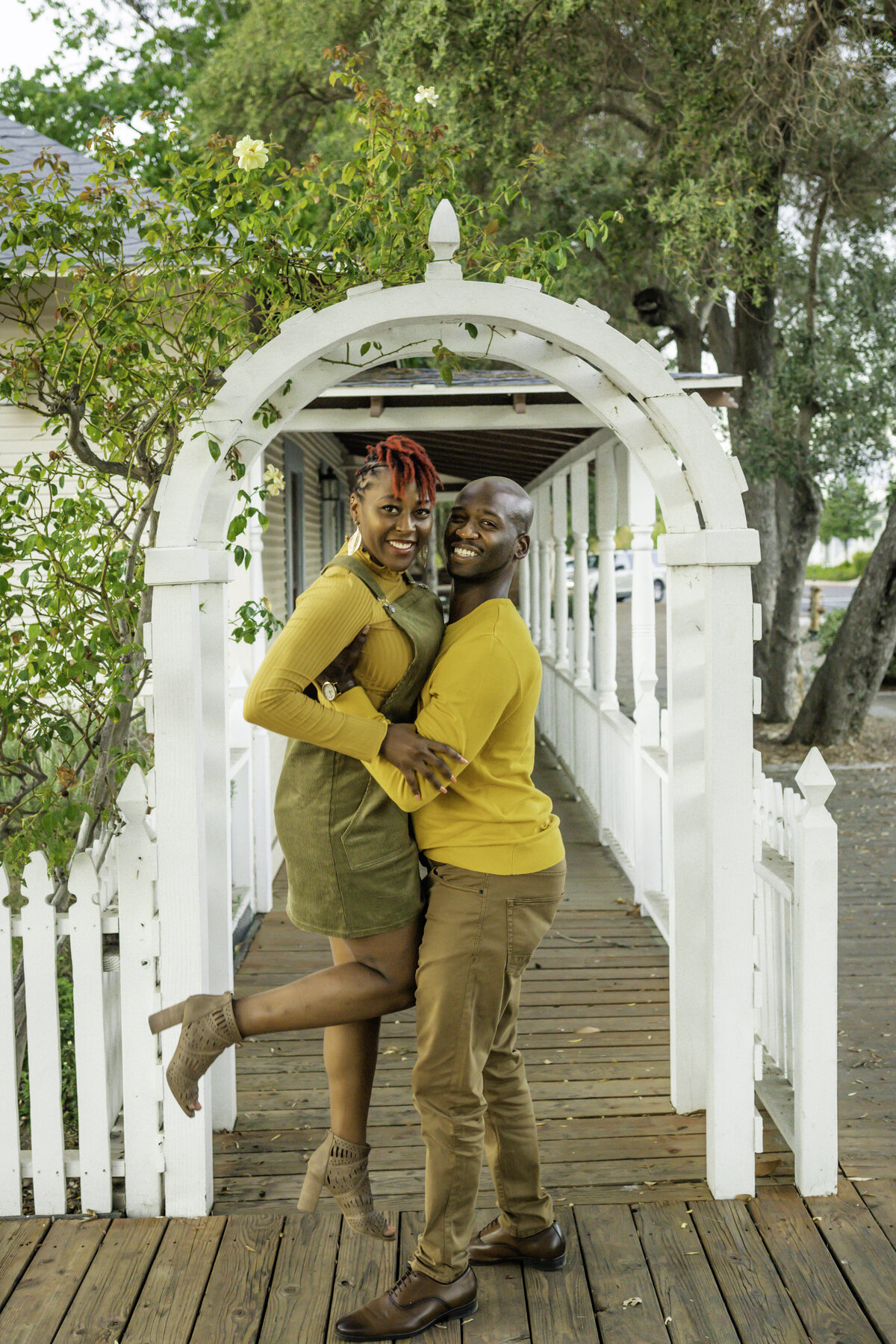 Black couple wearing yellow and green and smiling