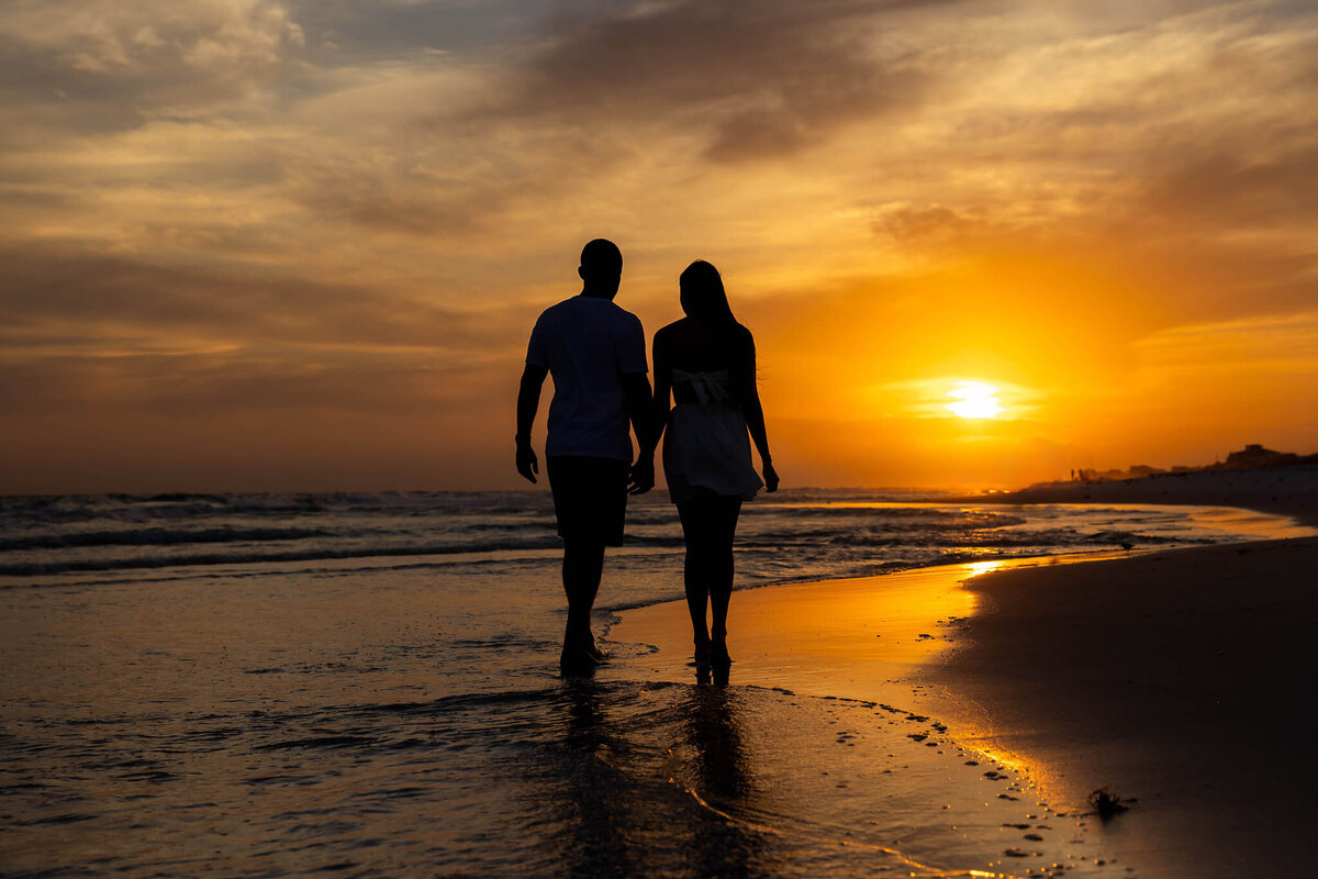 newly married couple honeymooning on 30a taking pictures at grayton beach state park on the beach.  