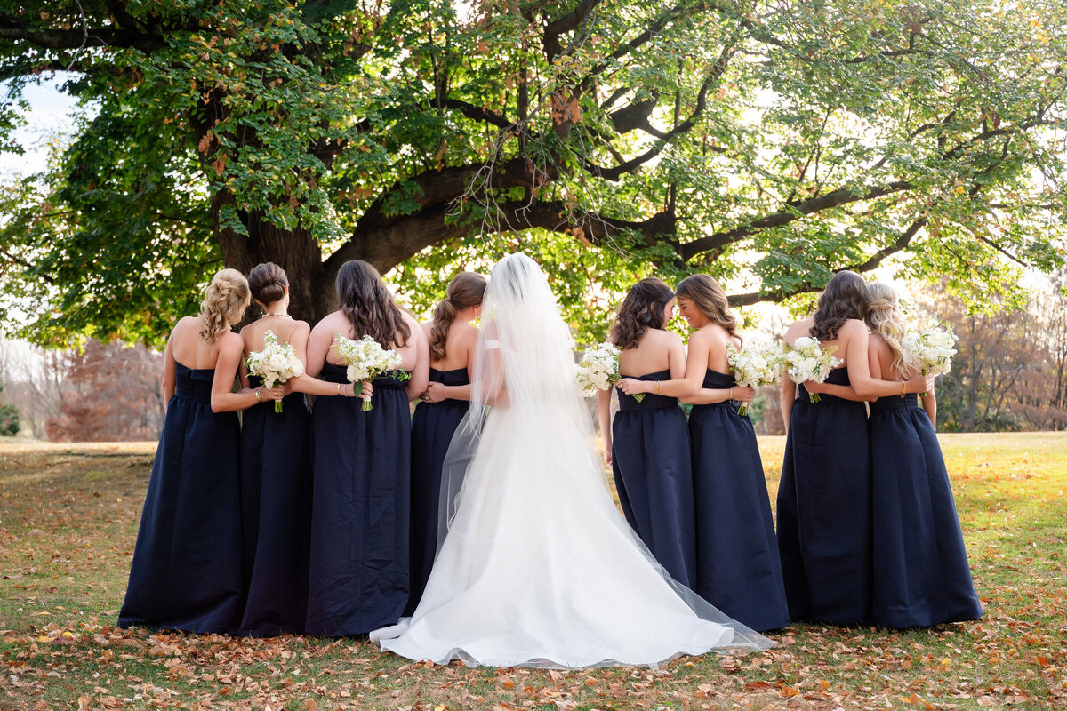 bride and lots of bridesmaids taking pictures on the schenley golf course in pittsburgh