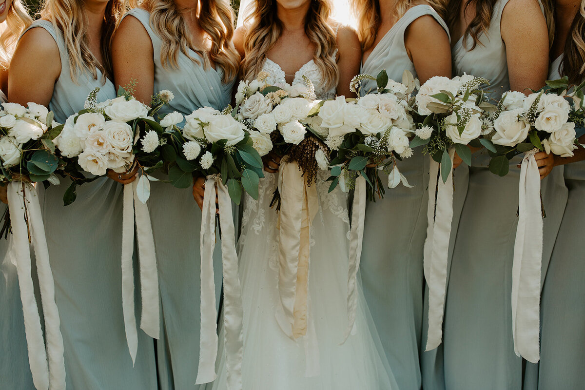 bride bridesmaids holding soft bouquets