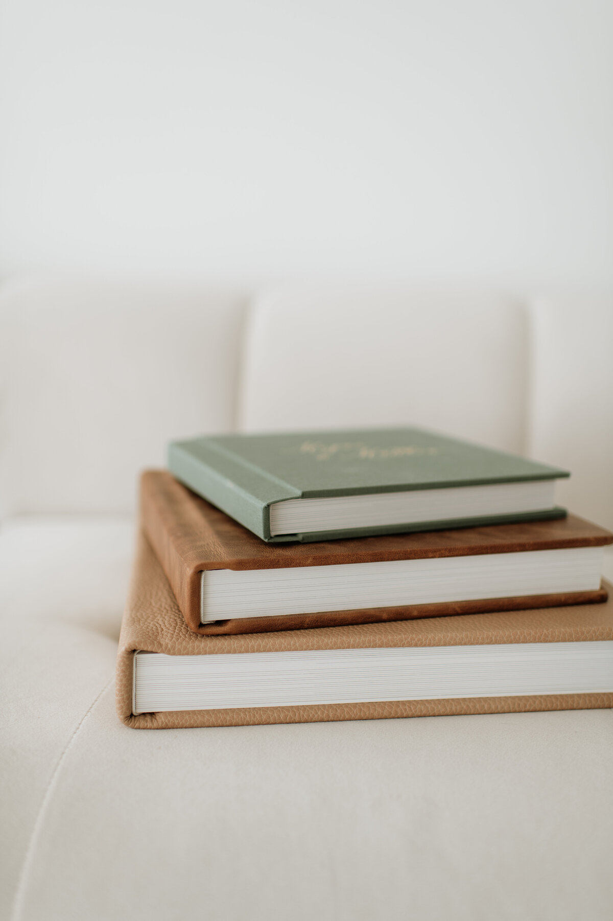 Stacked wedding albums on table