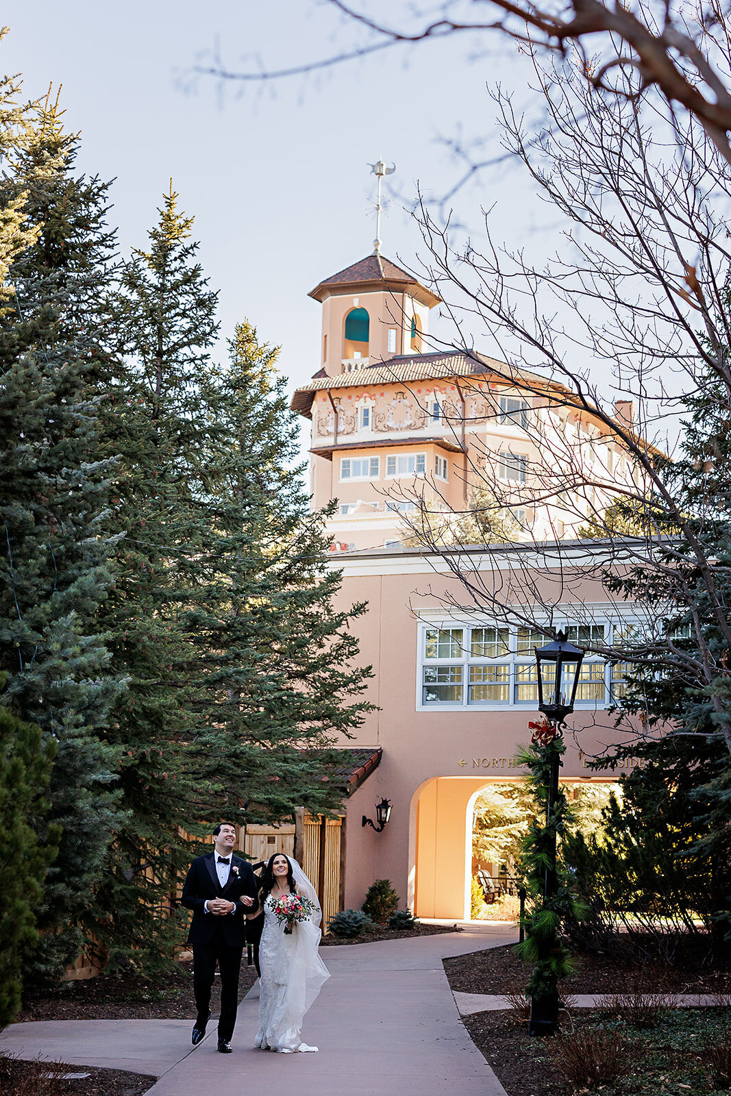 Bride and groom walk together at The Broadmoor Hotel in Colorado Springs, Colorado.