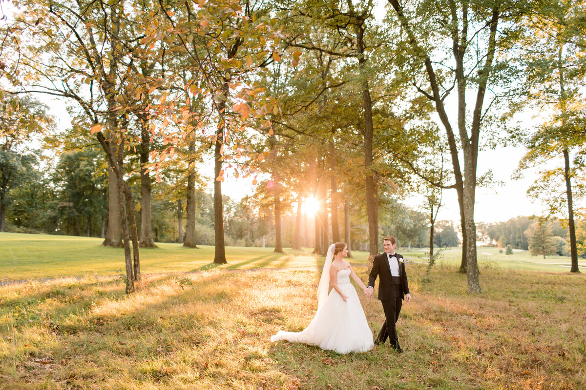 Delaware couple walking in the woods in wedding attire