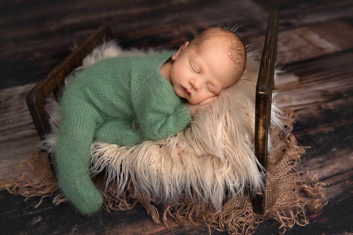 Wellington newborn studio portrait of newborn baby boy in green and brown.