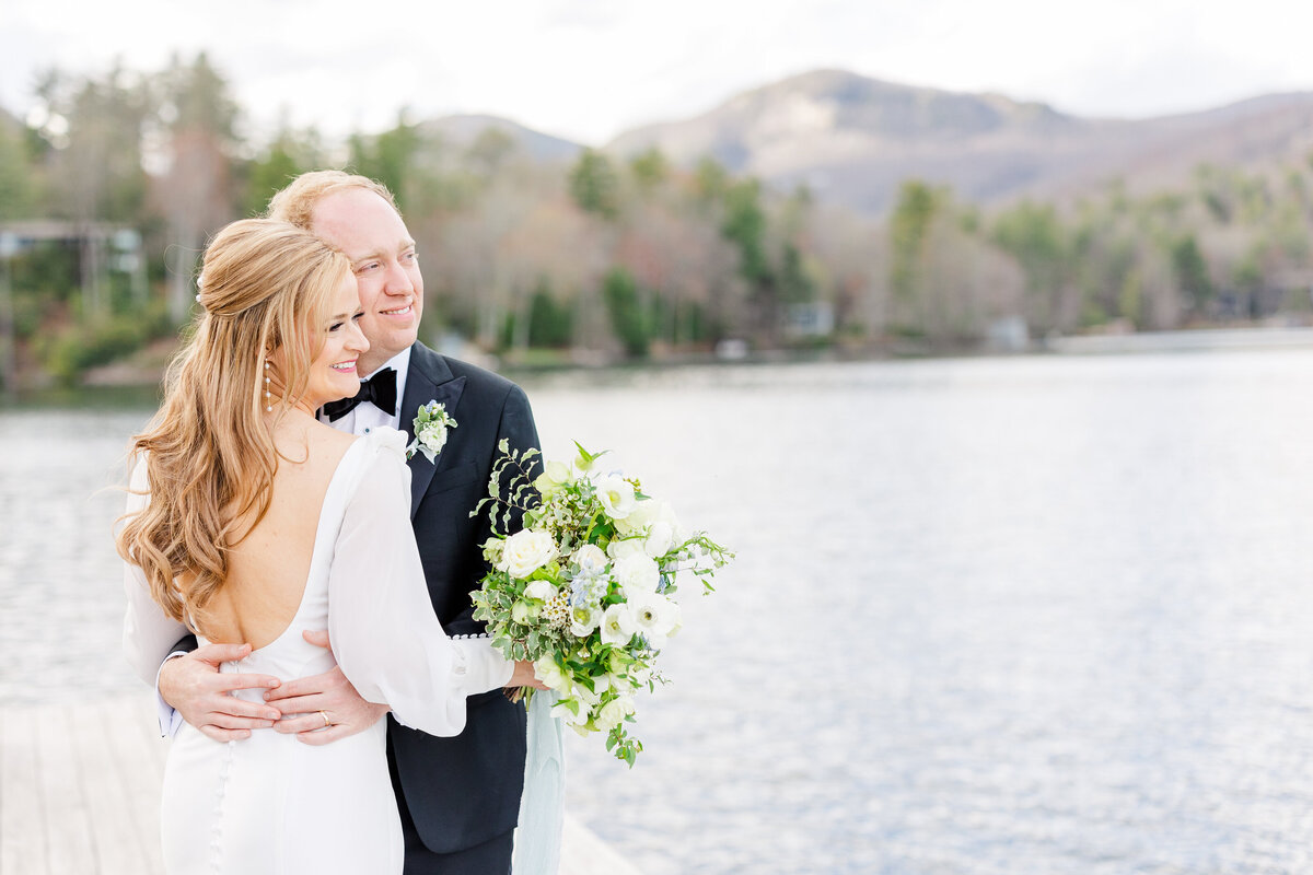 bride and groom smiling on a dock at the Greystone Inn