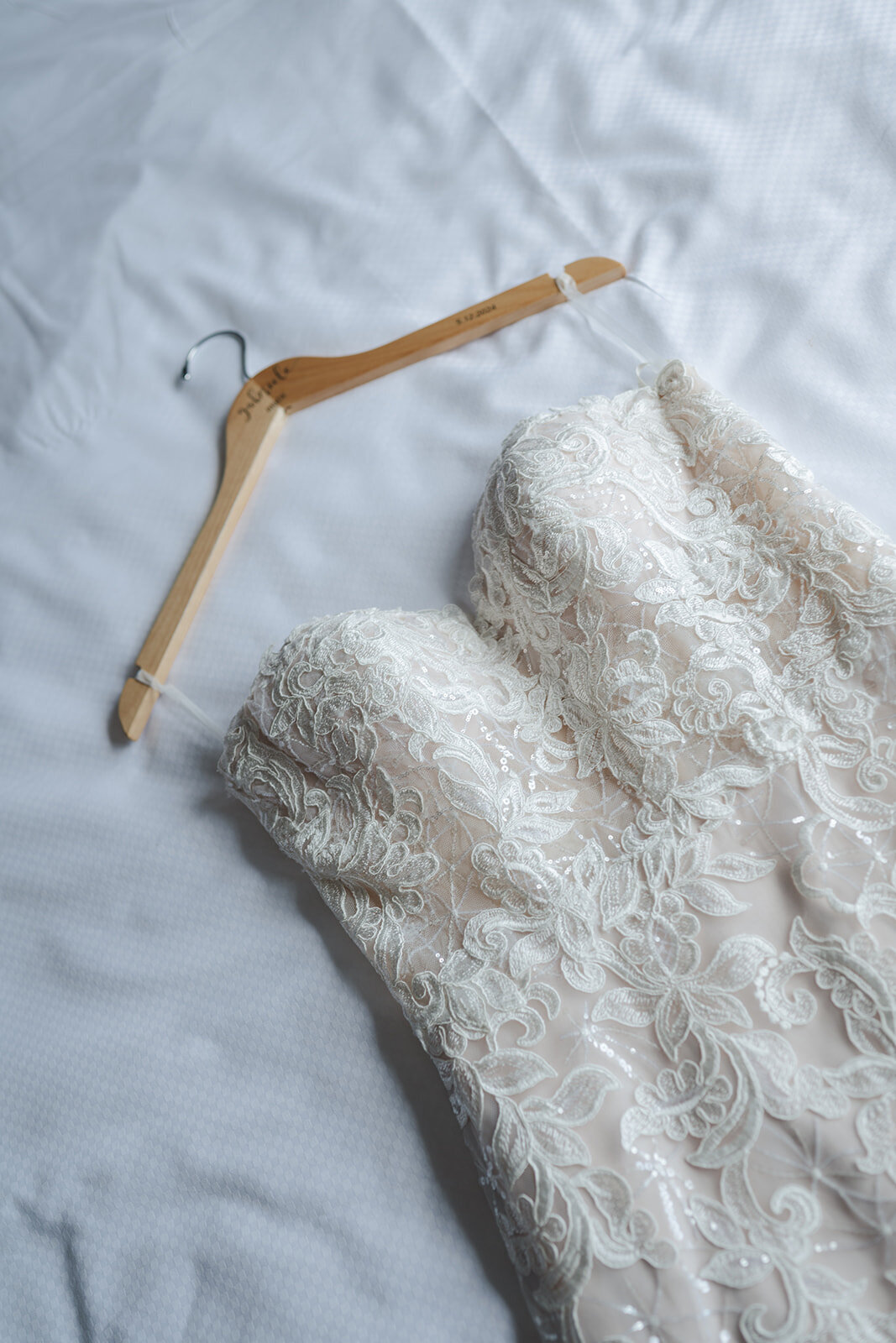 Close-up of the bride’s delicate lace wedding dress and natural, airy bouquet.