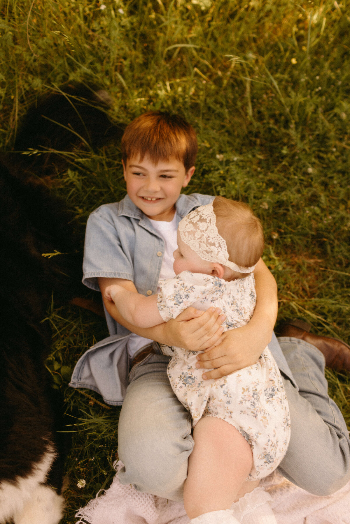 Parents and kids holding hands in open field during Nashville TN family session
