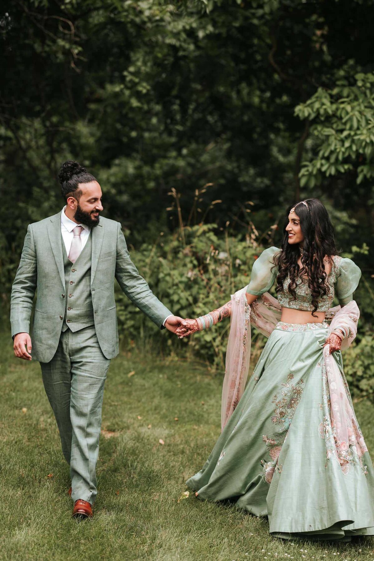 South Asian bride and groom holding hands after a day's worth of ceremonies enjoying a moment of isolation in Easton, Pennsylvania.