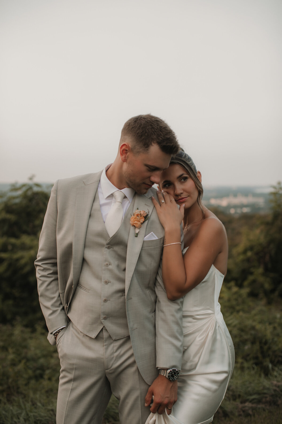 bride leaning on groom holding hands
