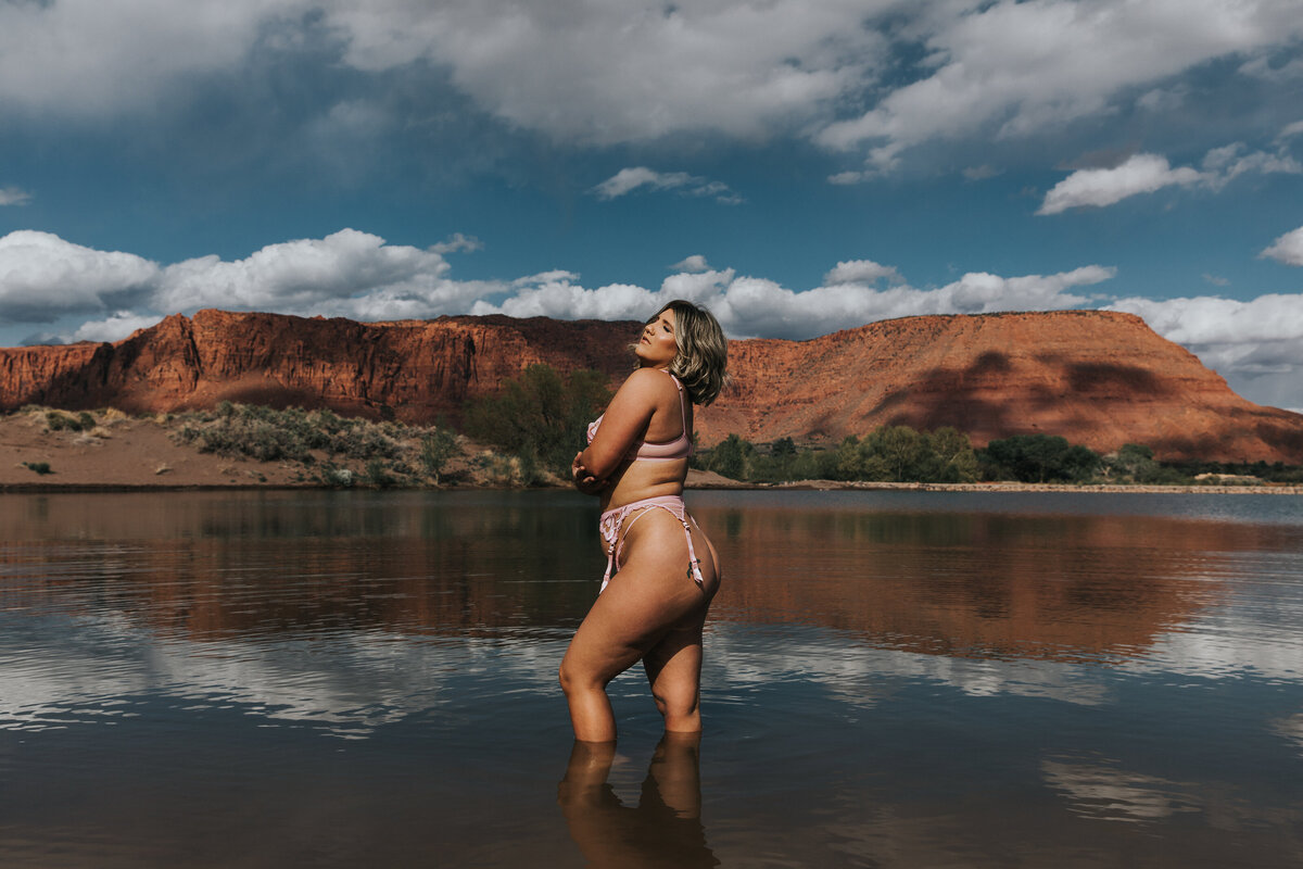 woman standing in a lake wearing lingerie