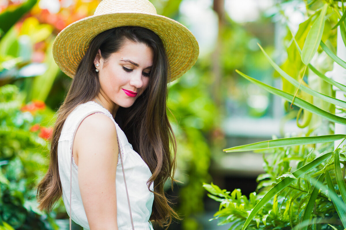 girl looking down in greenhouse