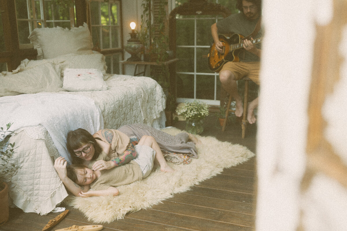 A mother and her son snuggling on a fur rug in Das Hinterhaus of Marietta, GA. 