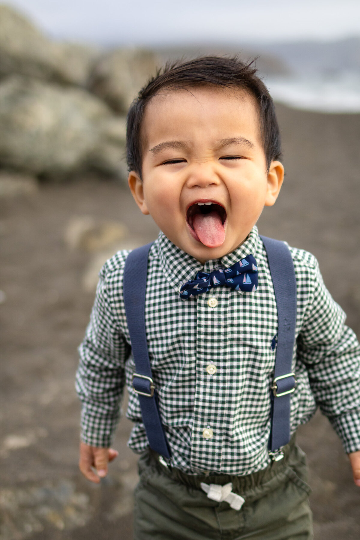 Toddler boy making a silly face and sticking out his tongue on the beach, included in Bay Area Maternity Portfolio - Ellobelle Photography
