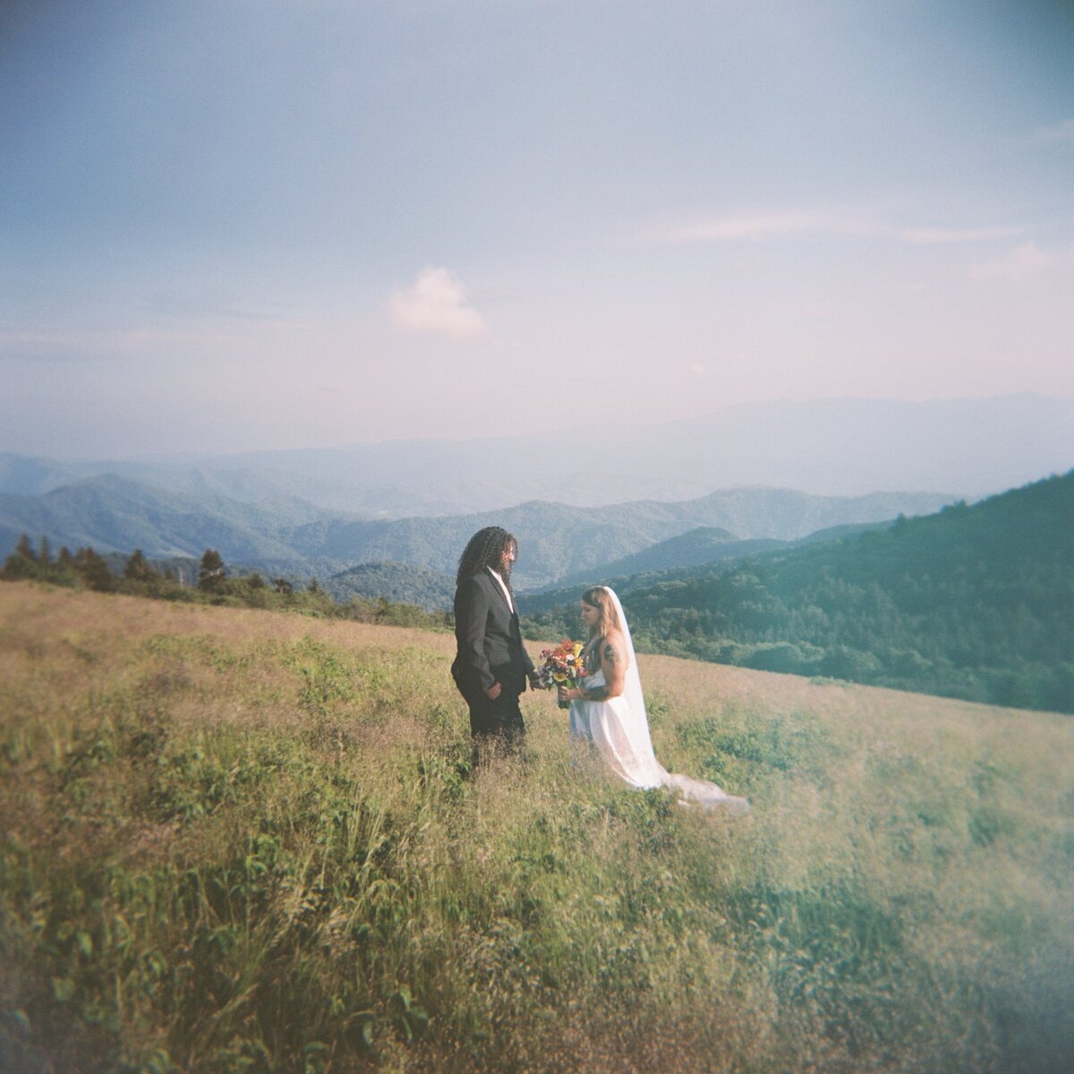 Couple standing on the side of Roan Mtn after their elopement.
