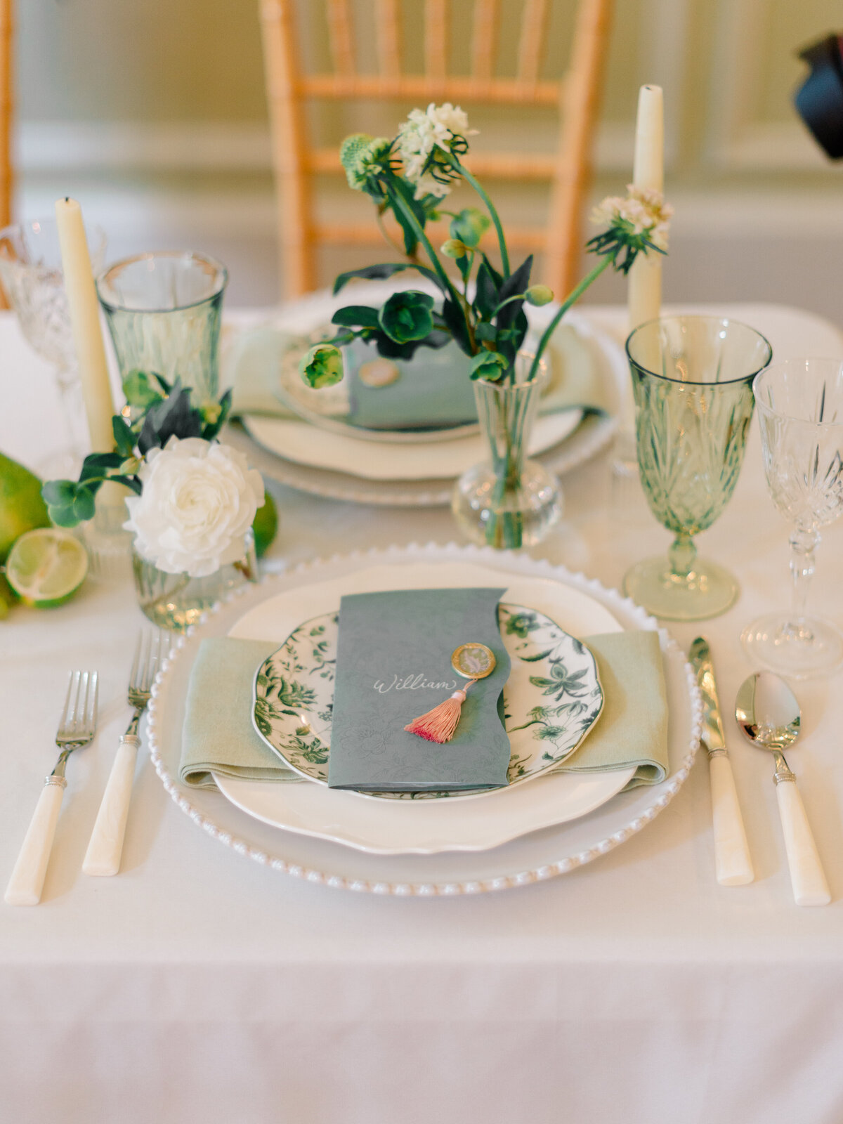 Luxury wedding place setting at Cairnwood Estate in Bryn Athyn, Pennsylvania, styled with vintage-inspired china, pearl-edged charger plates, and custom calligraphy name cards. Captured by Philadelphia Fine Art Wedding Photographer Elizabeth Kane, this elegant tablescape reflects timeless East Coast wedding design and refined heirloom details.