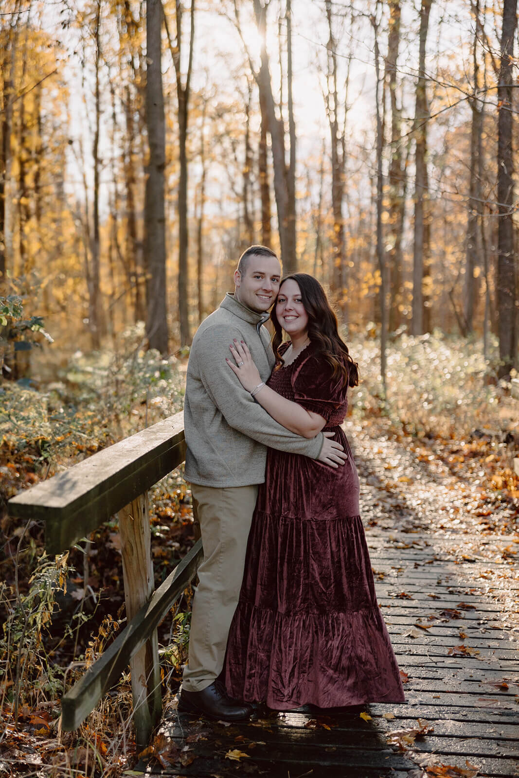 Couple embracing in a forest area at  Finger Lakes Maternity session