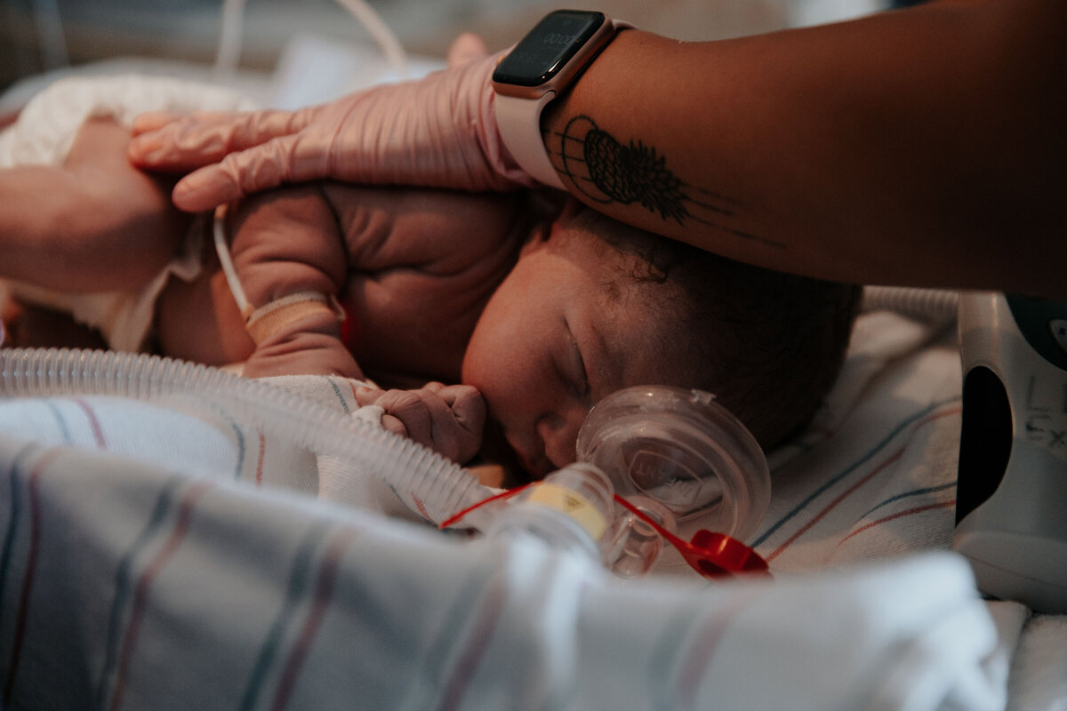 newborn baby boy being tended to by a hospital labor and delivery nurse
