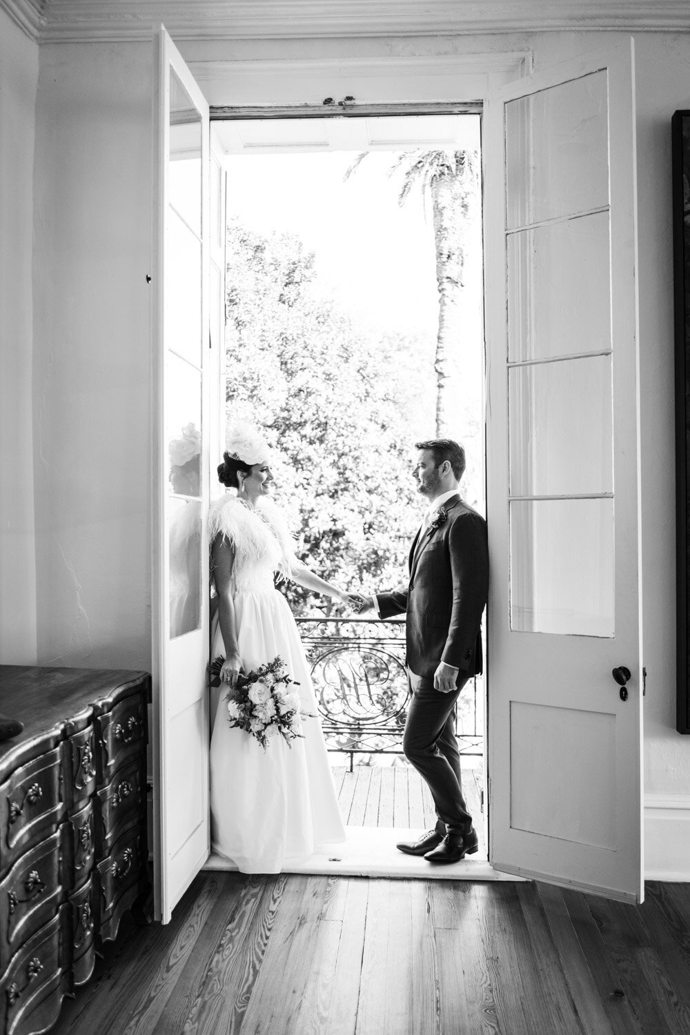 Bride and groom in balcony doorway