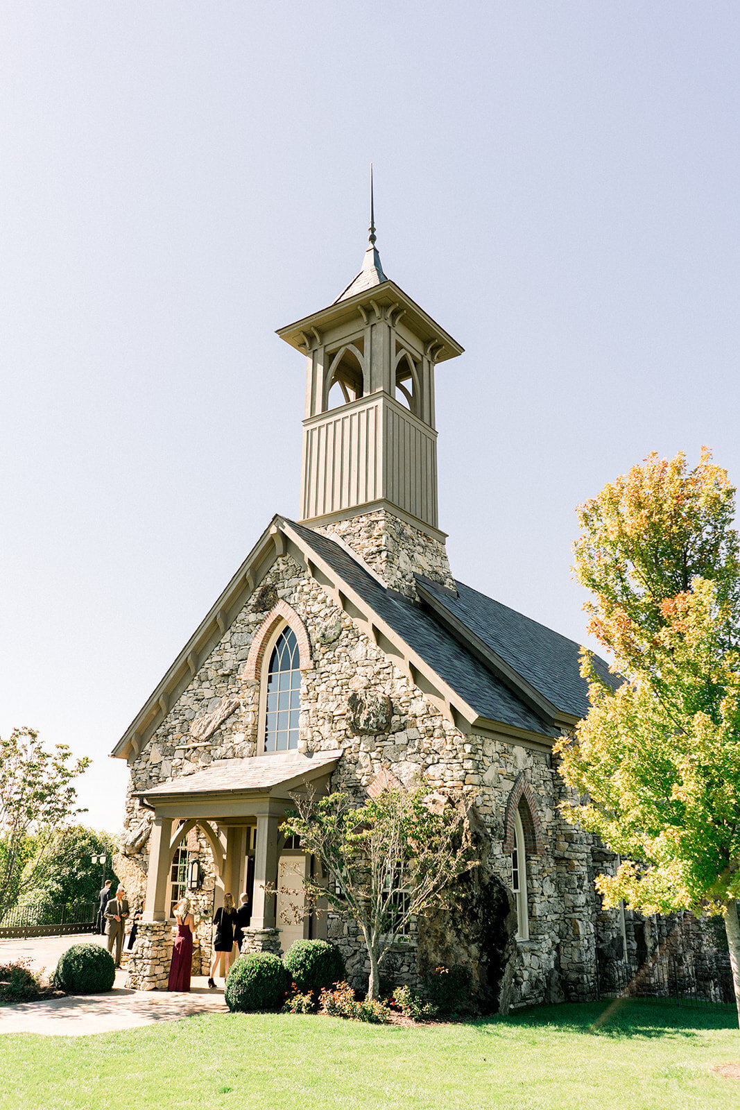 a small church with brown stonework