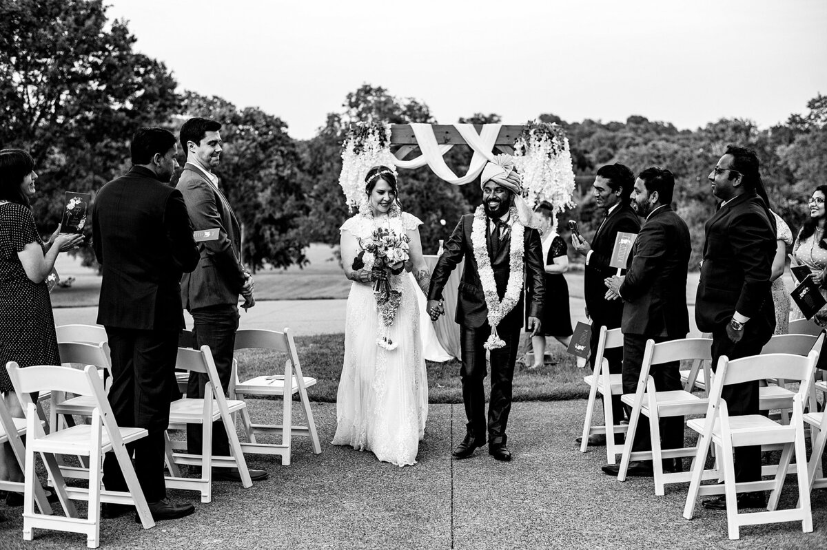 Bride and groom walk down the aisle after their Hindu/Christian wedding at Ravenswood Mansion.