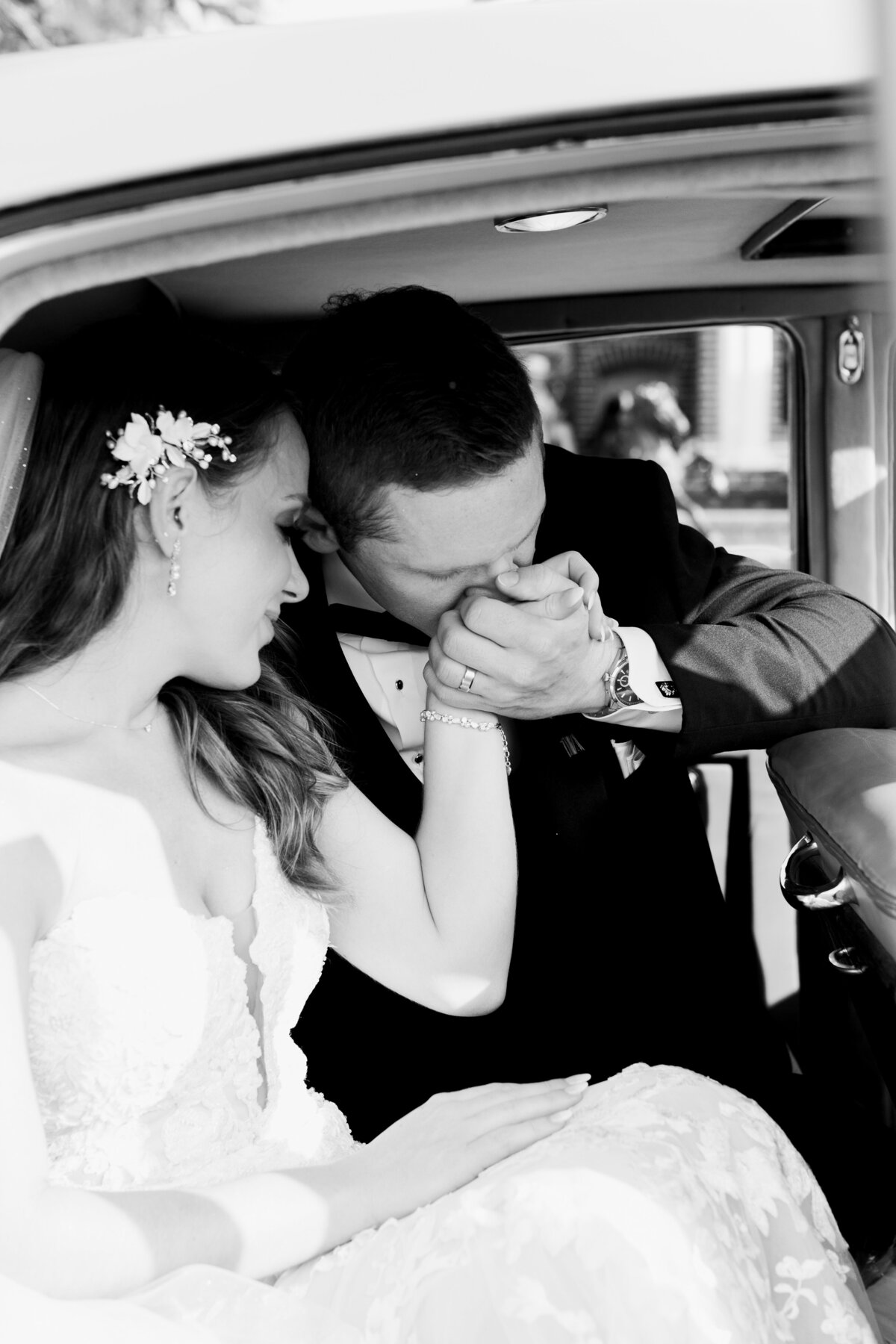 groom kissing brides hand