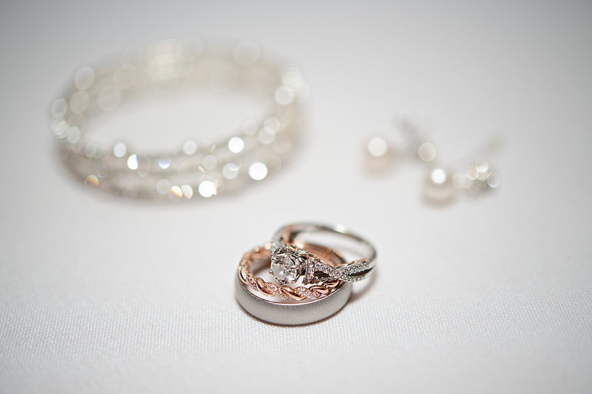 Silver and rose gold engagement and wedding rings with pearl earrings and bracelet