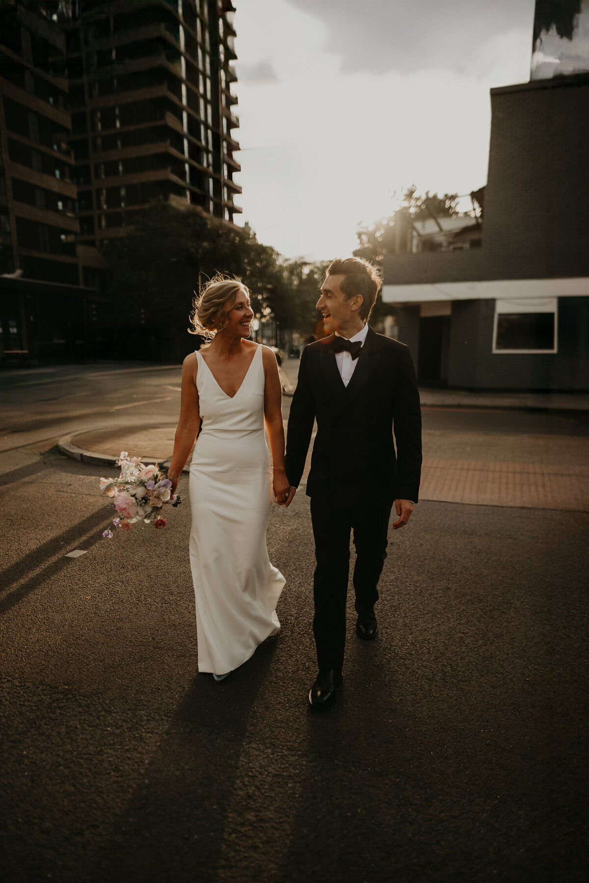 A bride and groom in the summer sun golden hour during their wedding portraits in London. 