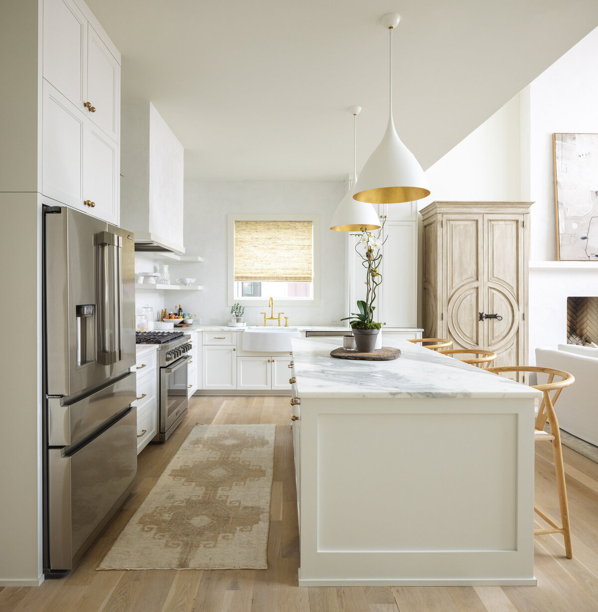 White kitchen with golden wood floors and accents