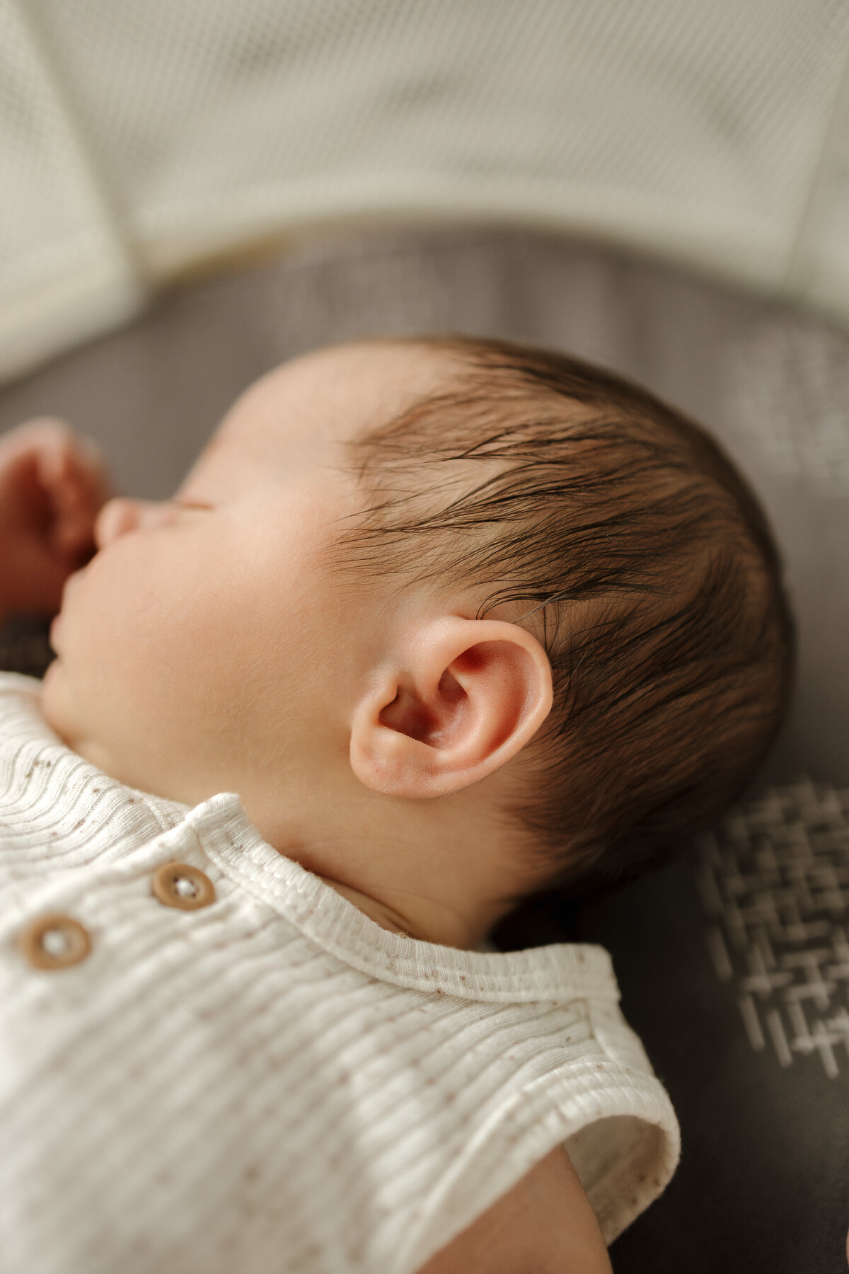 lifestyle in home newborn session baby boy ear and profile in longmont colorado with alexis adkins photography