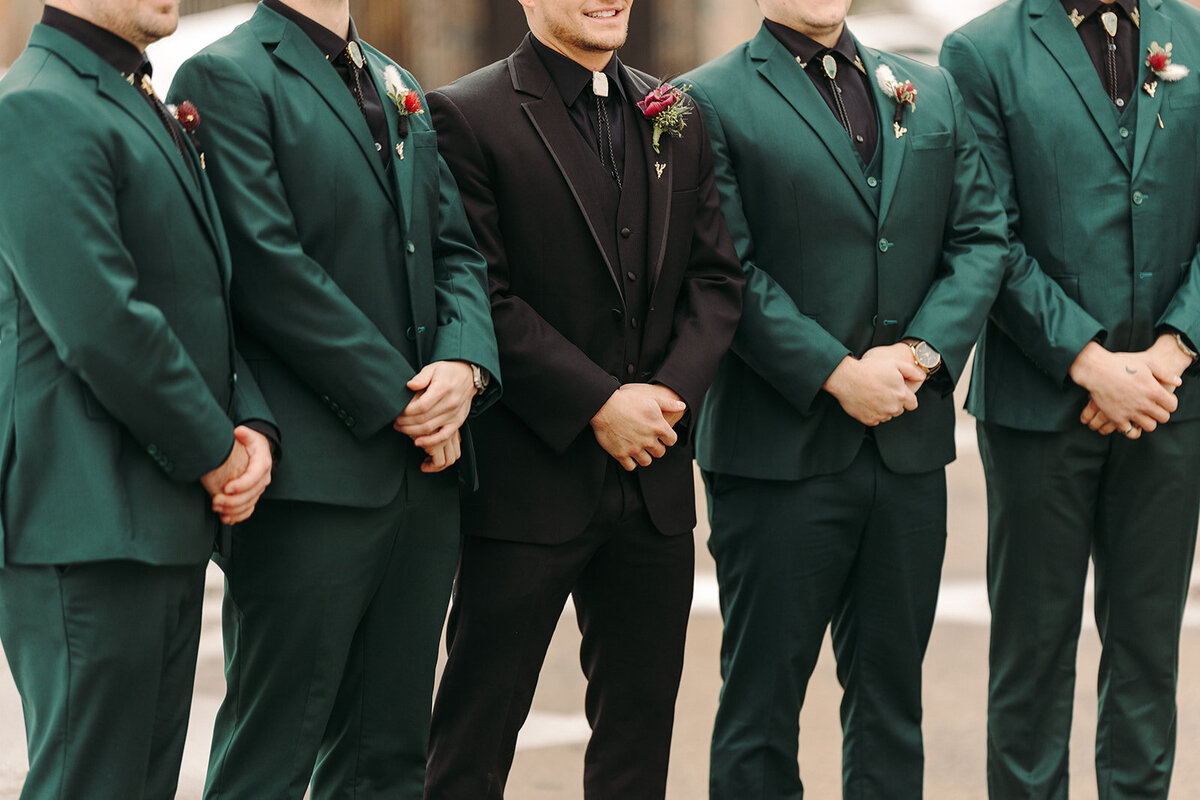 Utah Wedding Photography capturing groom standing with groomsmen wearing green suits