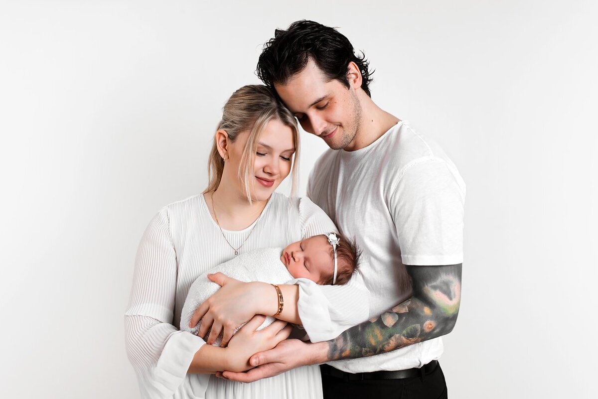 Mother and father holding newborn baby girl