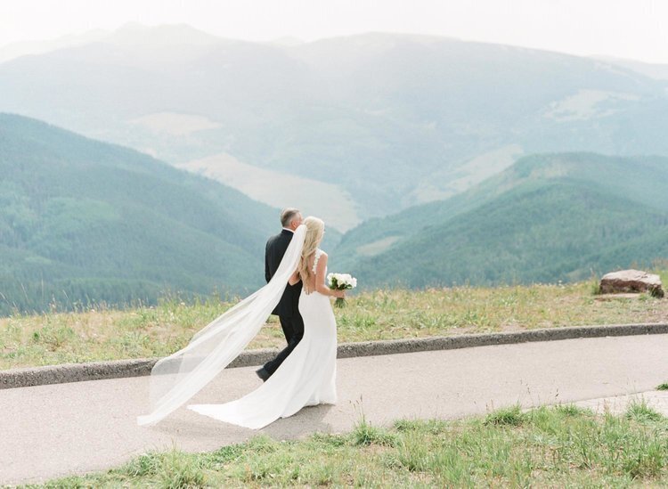 Bride walking toward the altar with a mountain backdrop