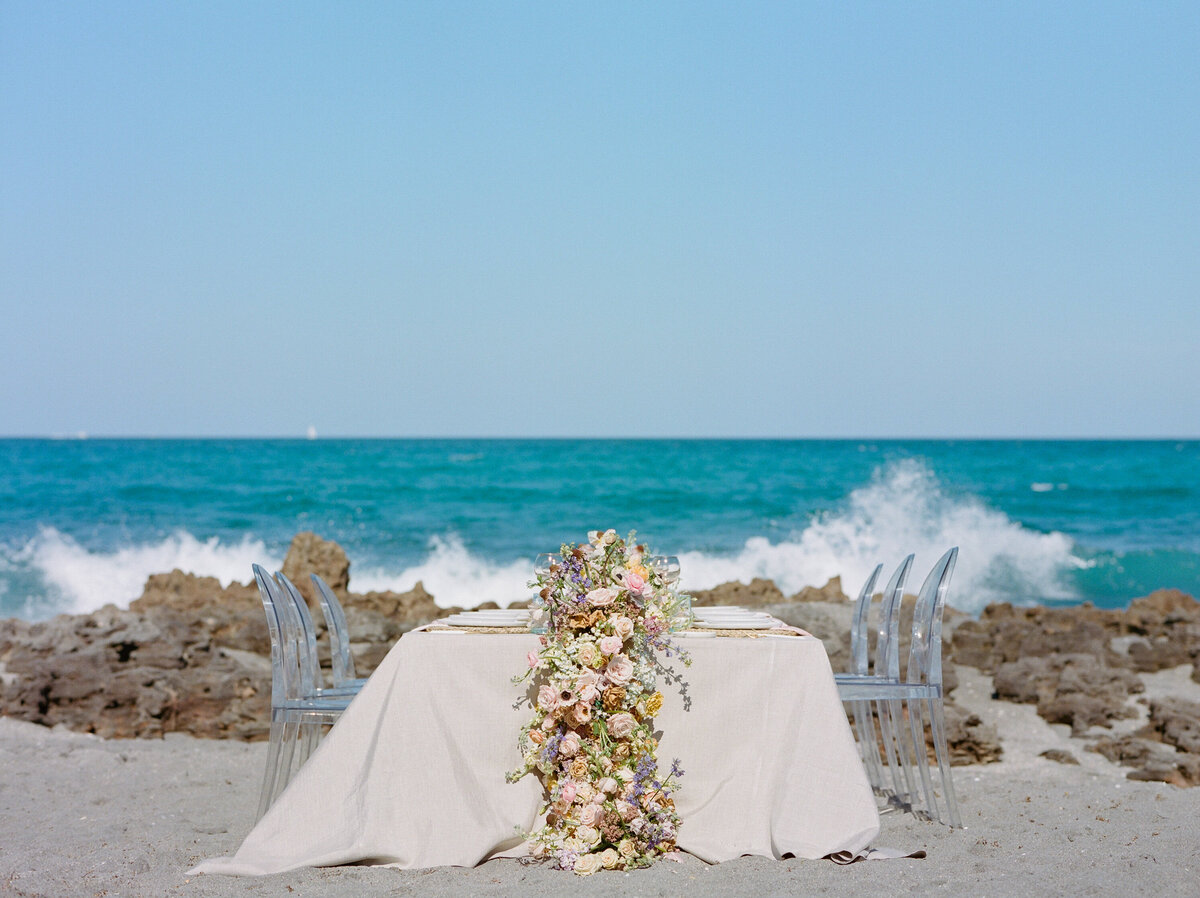 Waves crash behind the table.