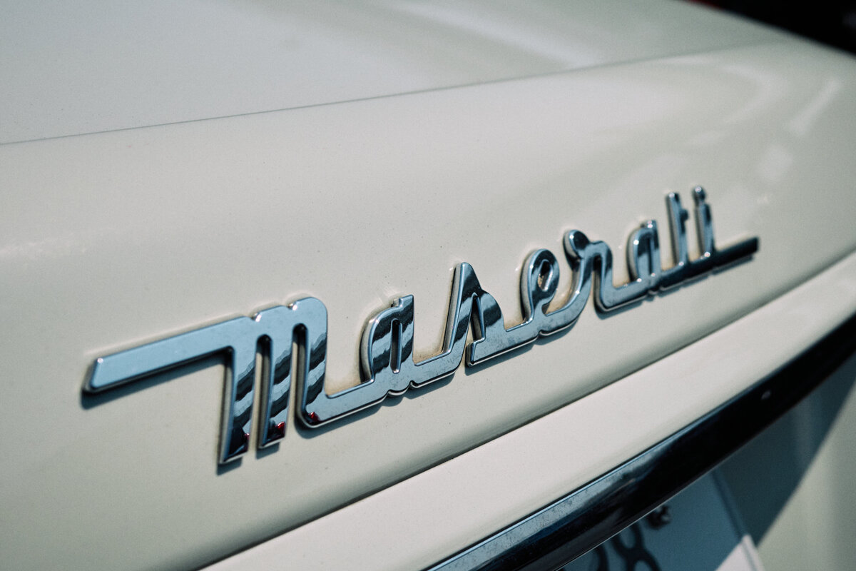 Close-up of the classic chrome Maserati emblem on the trunk, capturing the elegance and prestige of the Italian luxury brand.
