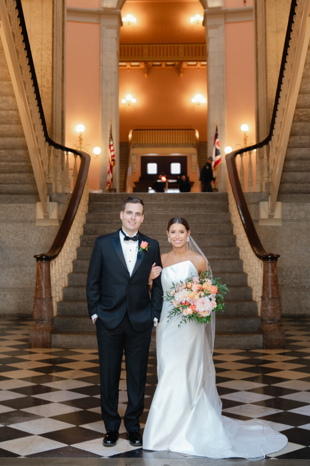 Bride and groom pose inside at The Ohio Statehouse in Columbus