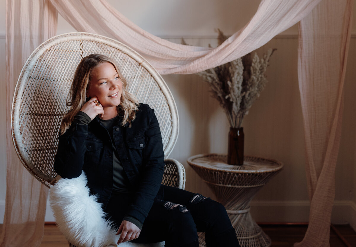 woman photographed in boho chic chair in studio in old town fort collins