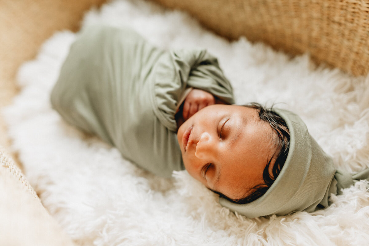 newborn baby sleeping in a crib.