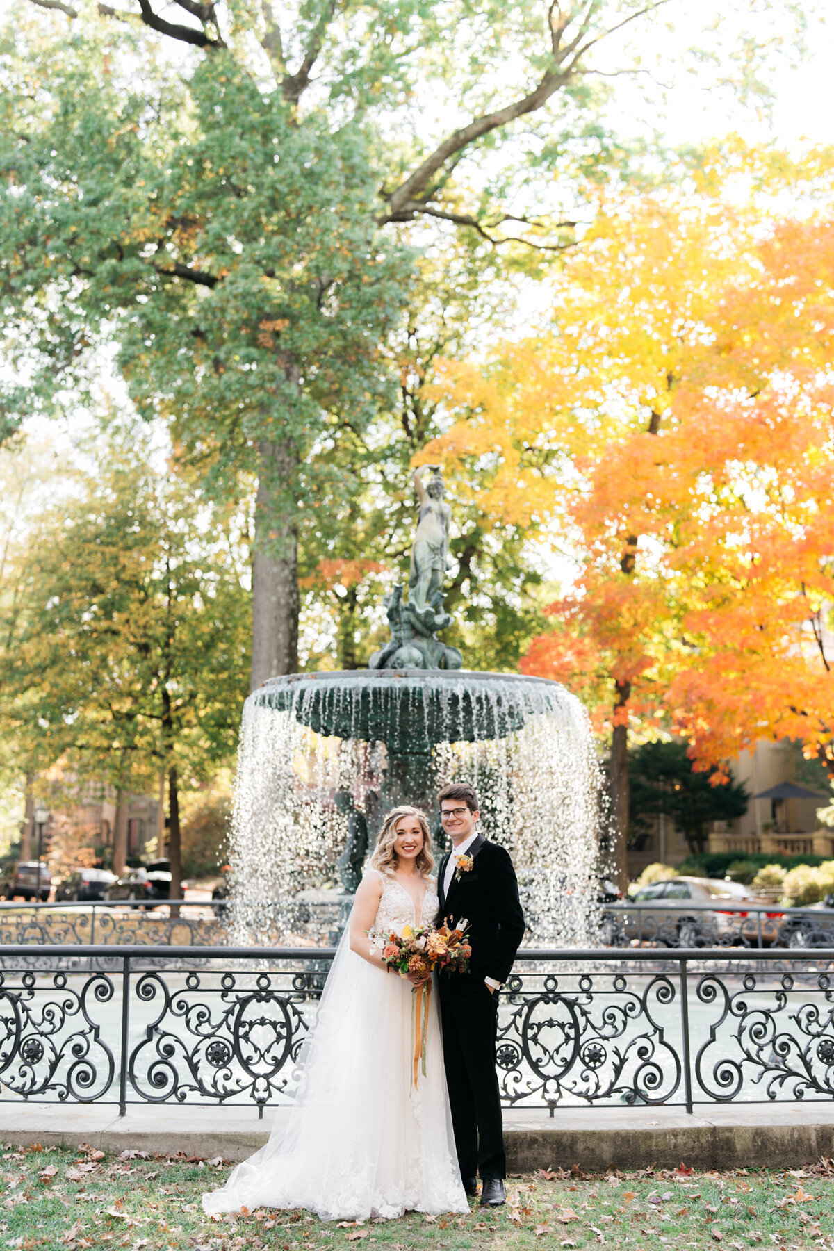 bride and groom posing in front of fountain at St. James Court