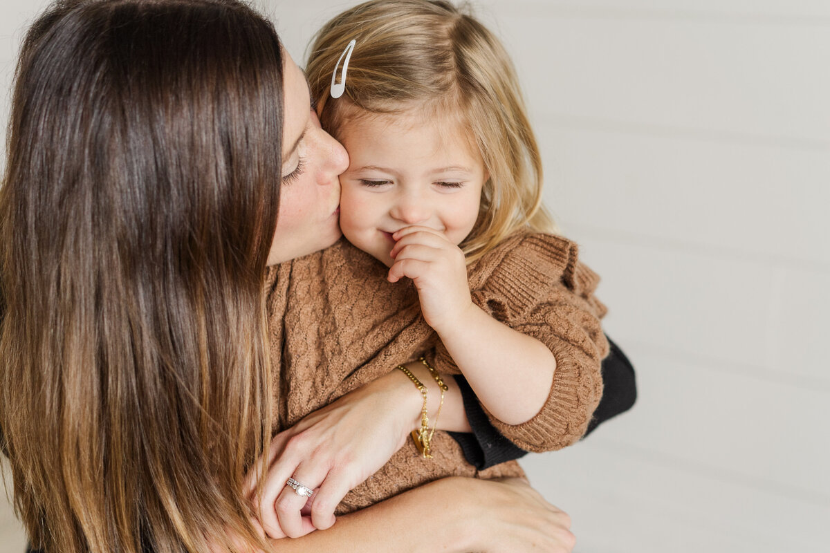 a mother hugs her daughter in a Minnesota Family session by Yantes Photo