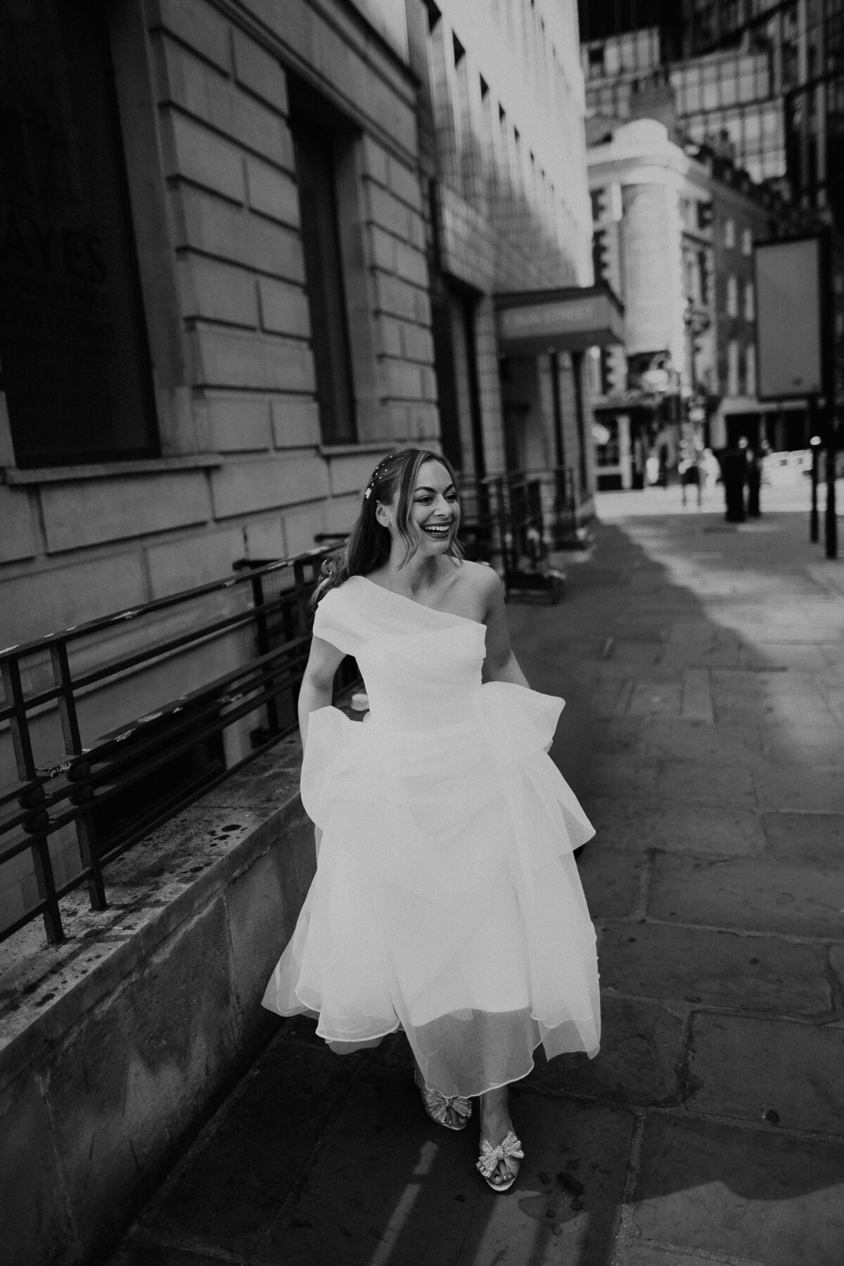 Bride walking through the streets of London to her wedding at The Barbican.