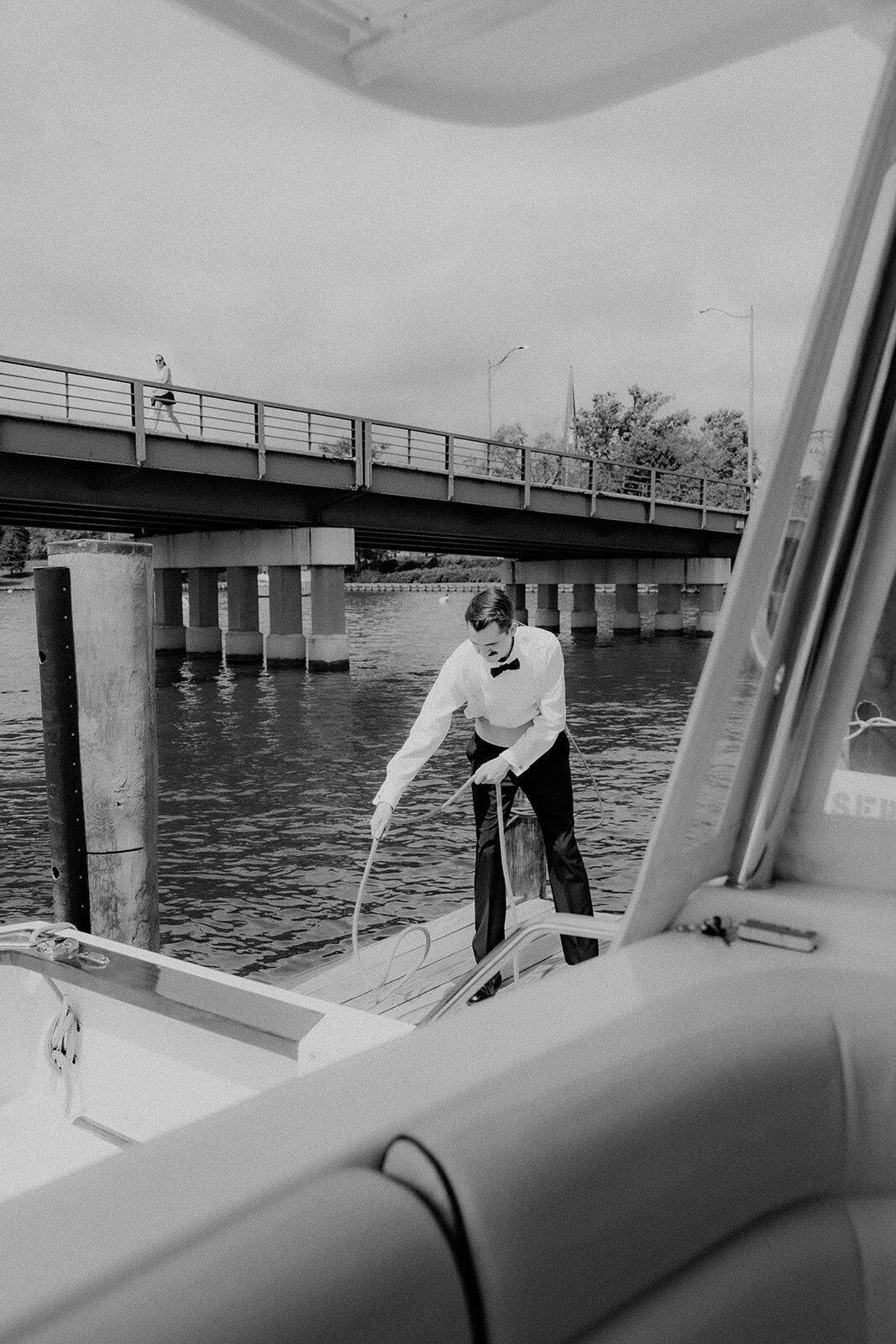 Groom tying boat to dock