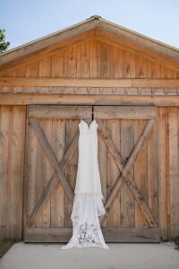 wedding-dress-hanging-on-barn-lewallen-farms-waleska-ga