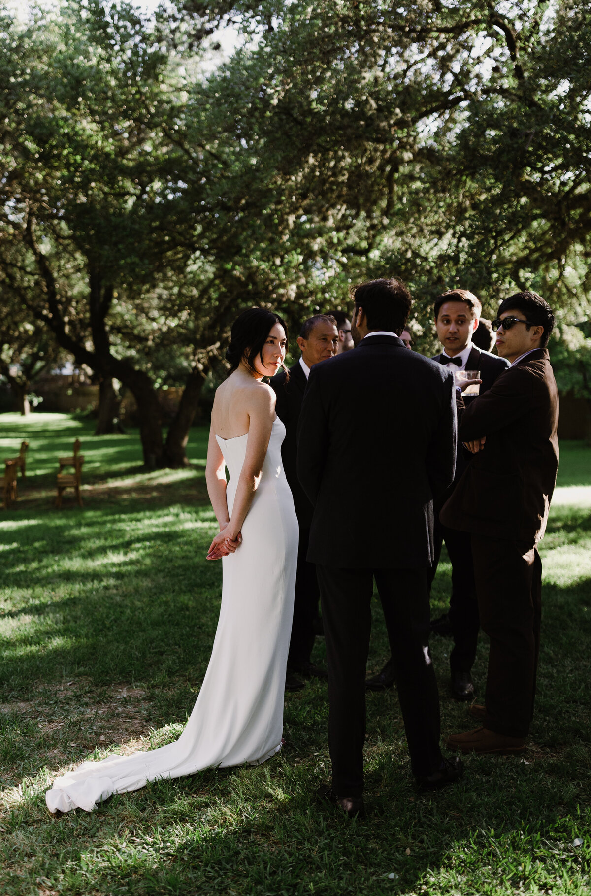 Bride and groom chatting with guests at outdoor wedding at Mattie's wedding venue in Austin