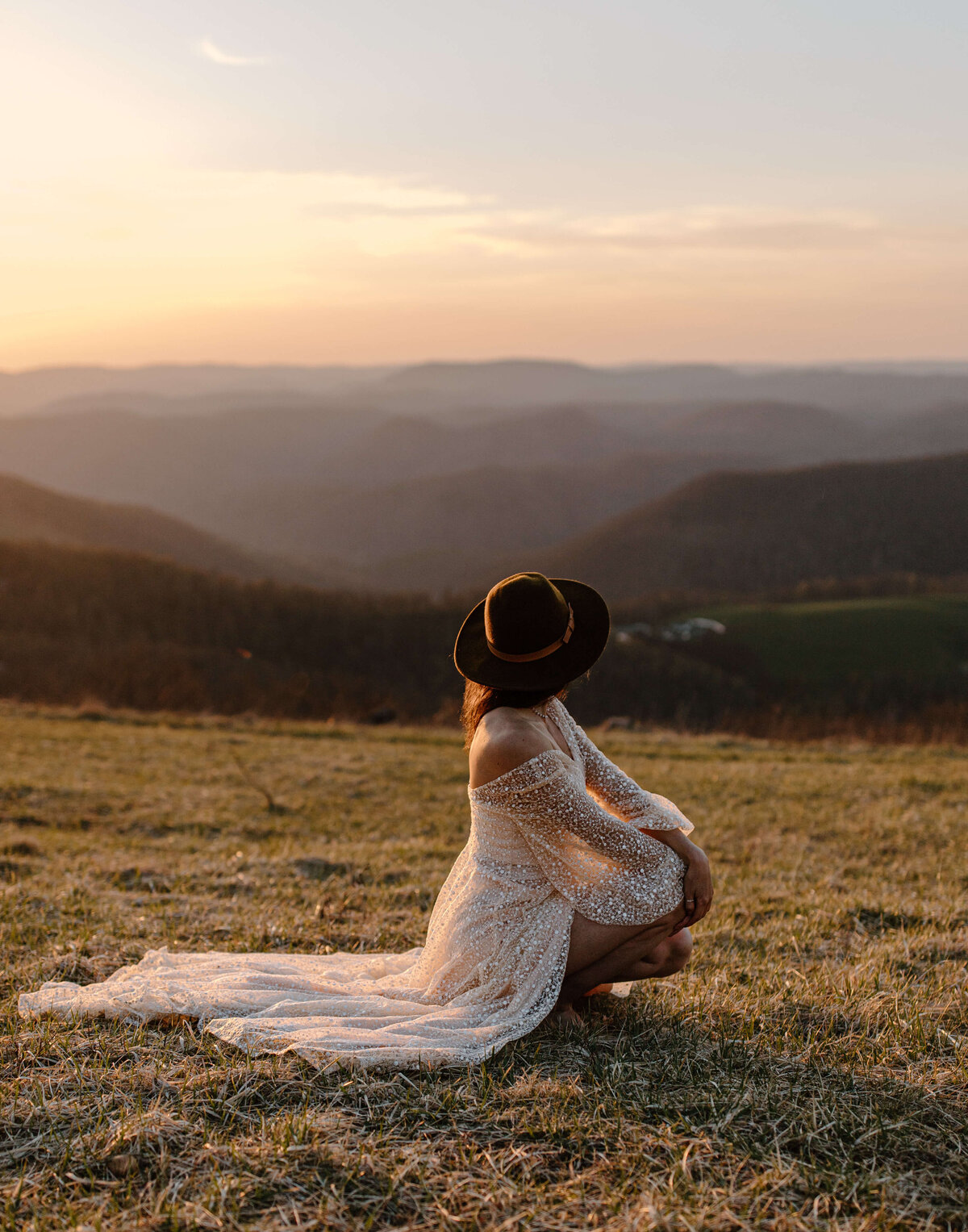 elopement bride long dress and hat gazing at sunset on maryland mountaintop inspiration photo